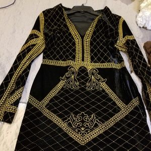A black velvet mini dress with gold trim